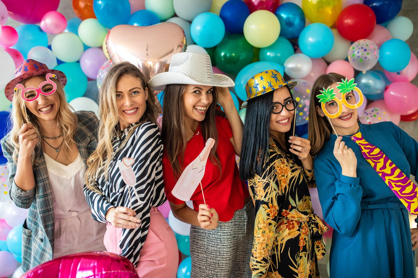 Bachelorette party with photo booth props and balloons